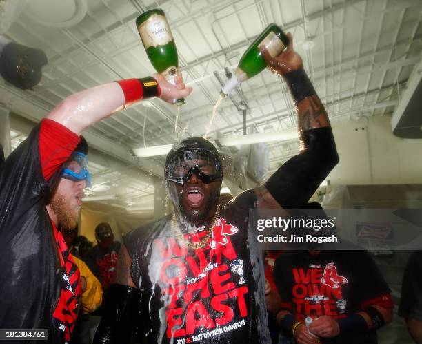 Mike Carp of the Boston Red Sox sprays David Ortiz champagne after winning the AL East Division by beating the Toronto Blue Jays at Fenway Park on...