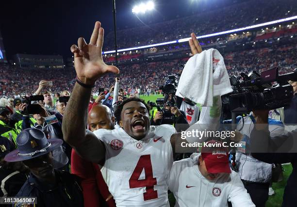 Jalen Milroe of the Alabama Crimson Tide celebrates their 27-24 win over the Auburn Tigers at Jordan-Hare Stadium on November 25, 2023 in Auburn,...