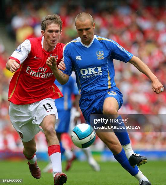 Arsenal's Belarus Midfielder Alexander Hleb vies for the ball with Portsmouth's English defender Matt Taylor during their Premiership match at home...