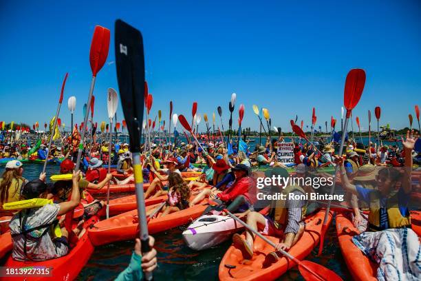 People take to the water as they continue blockade the access to the coal port in protest for climate action at Horseshoe Beach on November 26, 2023...