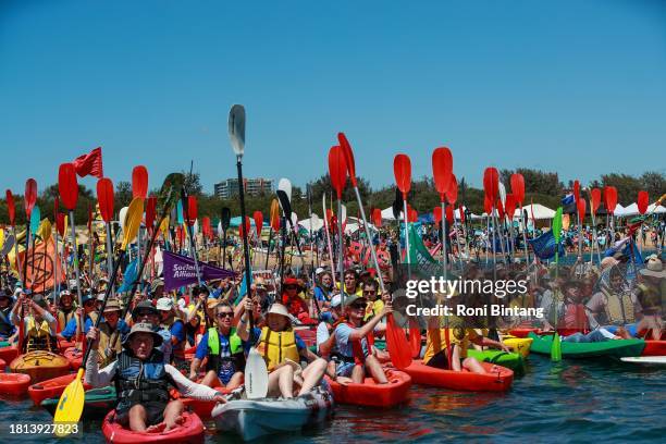 People take to the water as they continue blockade the access to the coal port in protest for climate action at Horseshoe Beach on November 26, 2023...