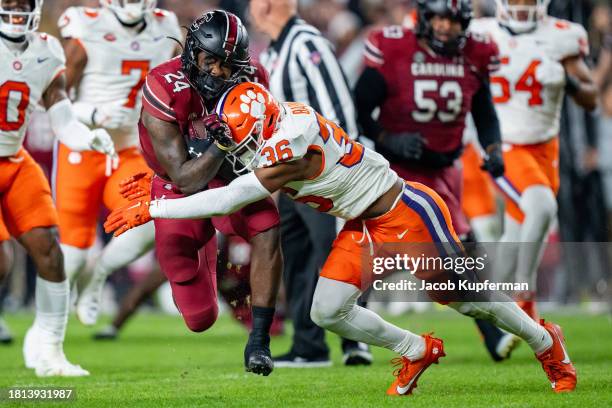 Khalil Barnes of the Clemson Tigers tackles Mario Anderson of the South Carolina Gamecocks in the first quarter during their game at Williams-Brice...