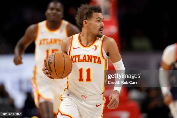 Trae Young of the Atlanta Hawks dribbles the ball against the Washington Wizards in the first half at Capital One Arena on November 25, 2023 in...