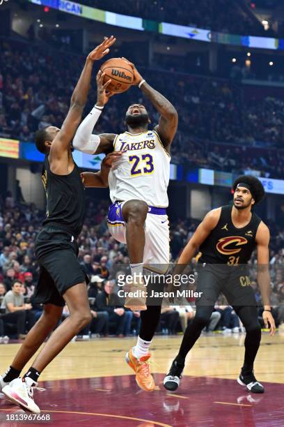 Evan Mobley of the Cleveland Cavaliers tries to block LeBron James of the Los Angeles Lakers during the first quarter at Rocket Mortgage Fieldhouse...