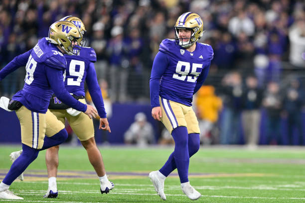 Jack McCallister, Jaden Green, and Grady Gross of the Washington Huskies react to scoring the game-winning field goal during the fourth quarter...