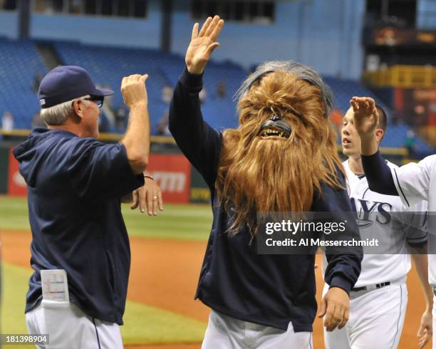 Infielder Luke Scott of the Tampa Bay Rays wears a Chewbacca mask during a celebration after a 5 -4 win in 18 innings against the Baltimore Orioles...