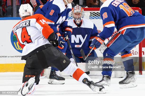 Sean Couturier of the Philadelphia Flyers takes a second period shot against Ilya Sorokin of the New York Islanders at UBS Arena on November 25, 2023...
