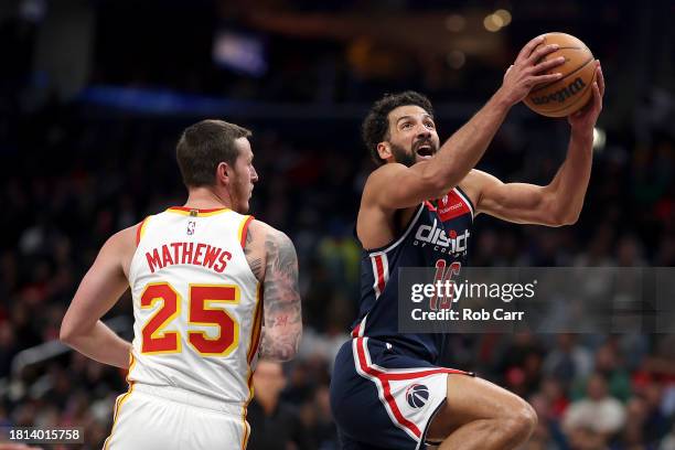 Anthony Gill of the Washington Wizards puts up a shot in front of Garrison Mathews of the Atlanta Hawks in the second half at Capital One Arena on...