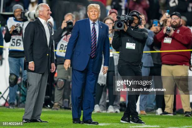 South Carolina governor Henry McMaster and former U.S. President Donald Trump make an appearance on the field at halftime during the game between the...