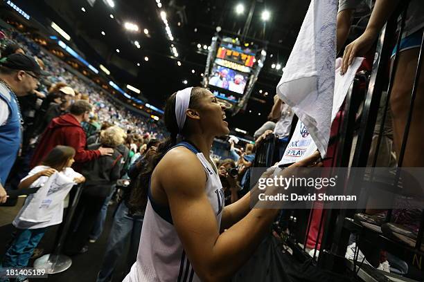 Maya Moore of the Minnesota Lynx celebrates with fans after defeating Seattle Storm during the WNBA Western Conference Semifinals Game 1 on September...