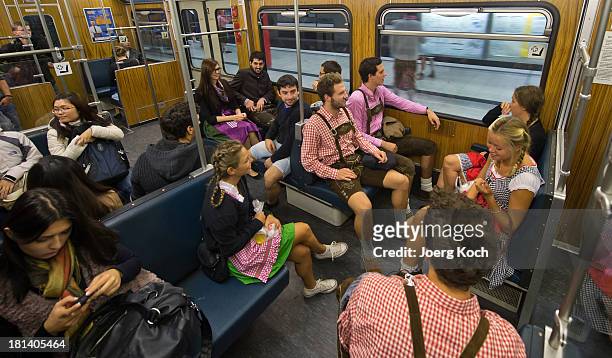 Visitors from Australia in bavarian style clothes go by underground to the Oktoberfest 2013 beer festival at Theresienwiese on September 21, 2013 in...