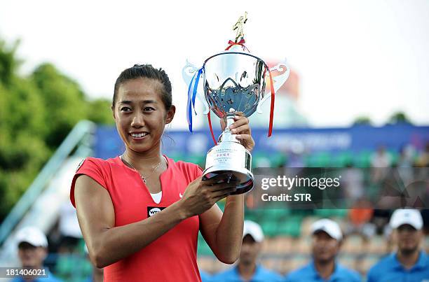 Zhang Shuai of China poses with the trophy after winning the Guangzhou Open tennis championship in Guangzhou, in southern China's Guangdong province...