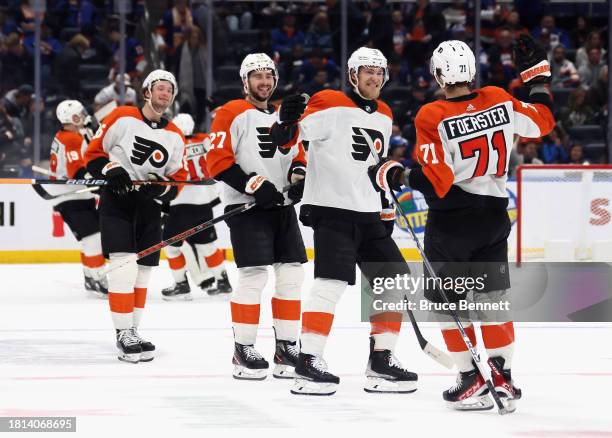 Tyson Foerster of the Philadelphia Flyers celebrates his game-winning shootout goal against the New York Islanders at UBS Arena on November 25, 2023...