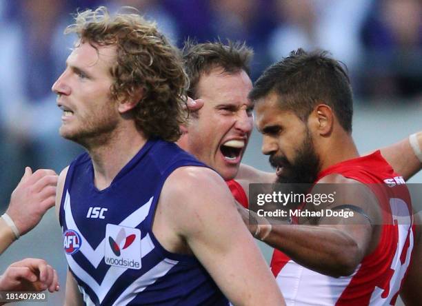 David Mundy of the Dockers reacts as Jude Bolton and Lewis Jetta of the Swans celebrate a goal during the AFL Second Preliminary Final match between...