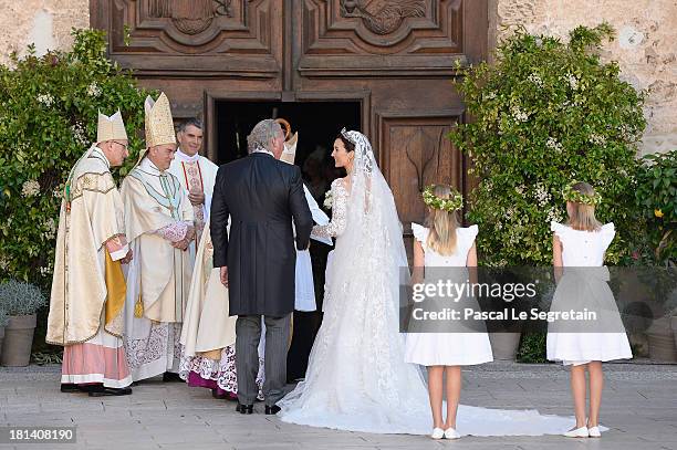 Princess Claire Of Luxembourg and her father Hartmut Lademacher are greeted by Most Reverend Jean-Claude Hollerich, Archbishop of Luxembourg,...