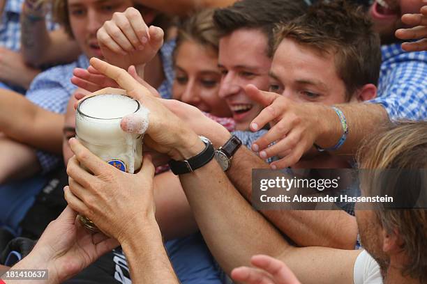 Revellers wait the first beer at the opening day of the Oktoberfest at Hofbraeu tent on September 21, 2013 in Munich, Germany. The Munich...