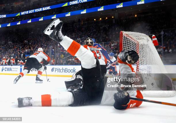 Rasmus Ristolainen of the Philadelphia Flyers slides into the net and topples over during the game against the New York Islanders at UBS Arena on...