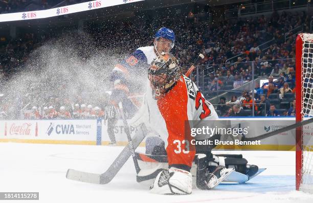 Samuel Ersson of the Philadelphia Flyers makes the save as Casey Cizikas of the New York Islanders looks for the rebound at UBS Arena on November 25,...