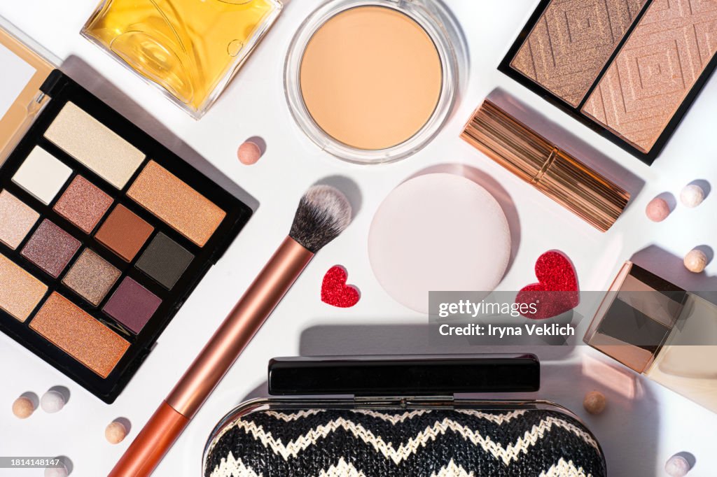 Set of White Black Clutch Bag and Cosmetic Make-up Products for a woman on white color background with Red Hearts.