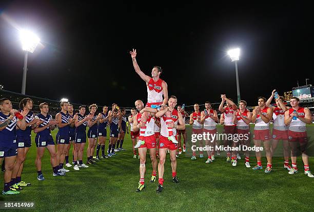 Jude Bolton of the Swans gets carried off by Jarrad Mcveigh and Ryan O'Keefe during the AFL Second Preliminary Final match between the Fremantle...