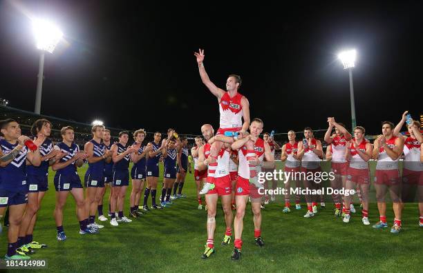 Jude Bolton of the Swans gets carried off for his last game by Jarrad Mcveigh and Ryan O'Keefe during the AFL Second Preliminary Final match between...