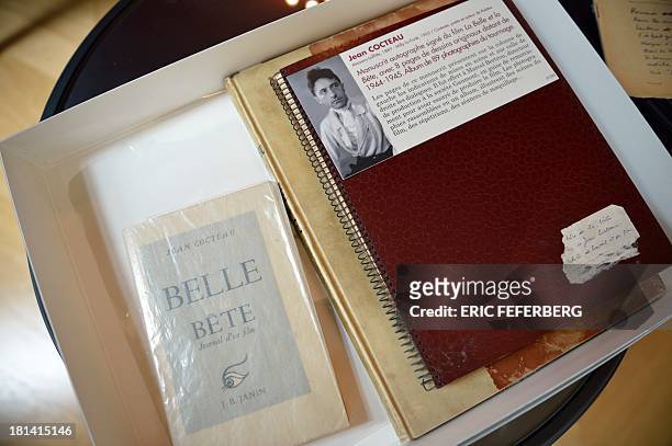 Page of the script of Jean Cocteau's movie "La Belle et la Bete" is shown on September 19, 2013 in Paris. AFP PHOTO /ERIC FEFERBERG