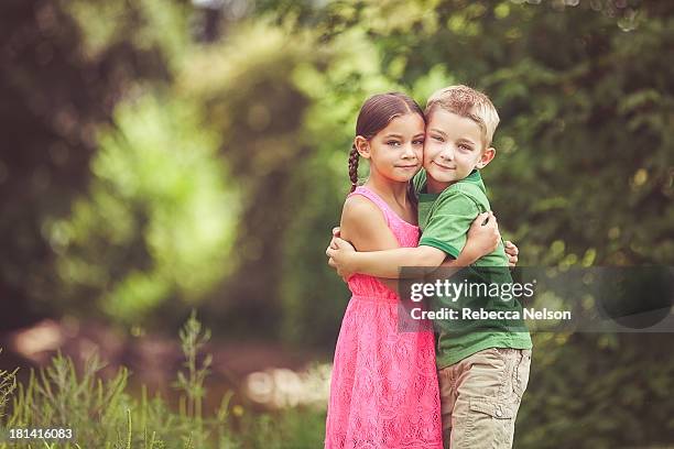 twins embracing - fraternal twin stock pictures, royalty-free photos & images