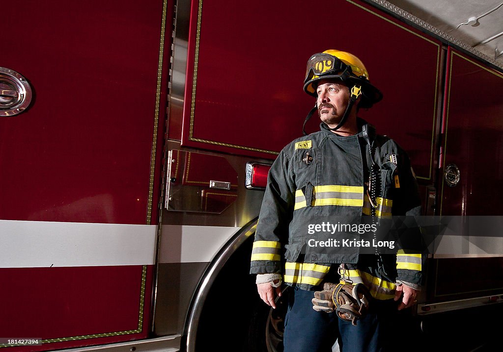 A firefighter standing in front of a fire truck