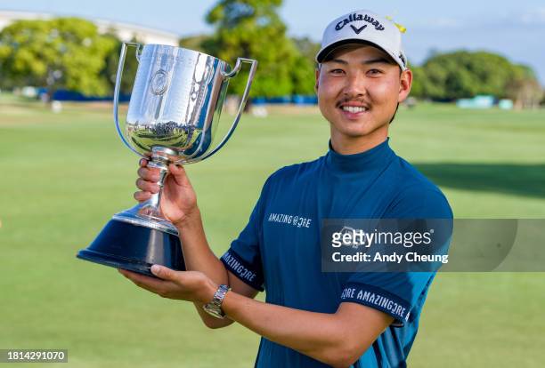 Min Woo Lee of Australia poses with the championship trophy Kirkwood Cup after victory on the 18th green during day four of the 2023 Australian PGA...