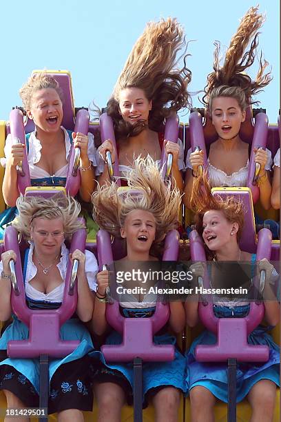 People enjoy a fairground ride during day 1 of the Oktoberfest 2013 beer festival at Theresienwiese on September 21, 2013 in Munich, Germany. The...