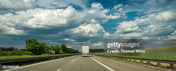 rear view of truck on freeway - autobahn stock-fotos und bilder