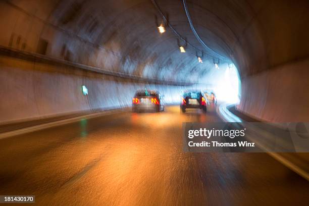 traffic in tunnel on wet road - light at the end of the tunnel car stock pictures, royalty-free photos & images