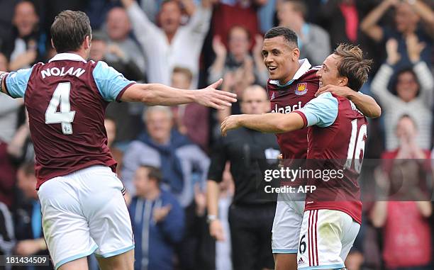 West Ham United's English midfielder Ravel Morrison celebrates scoring his team's first goal with West Ham United's English midfielder Mark Noble and...