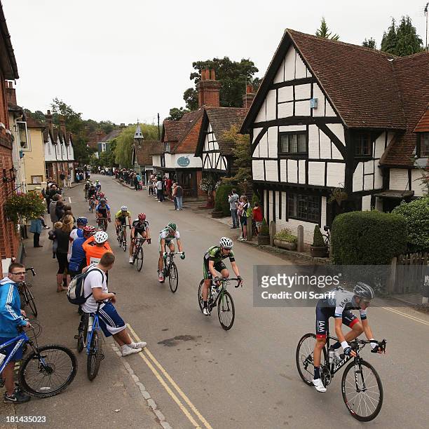Riders pass through the small village of Shere during stage seven of the Tour of Britain from Epsom Racecourse to Guildford on September 21, 2013 in...
