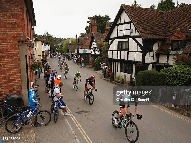 Riders pass through the small village of Shere during stage seven of the Tour of Britain from Epsom Racecourse to Guildford on September 21, 2013 in...