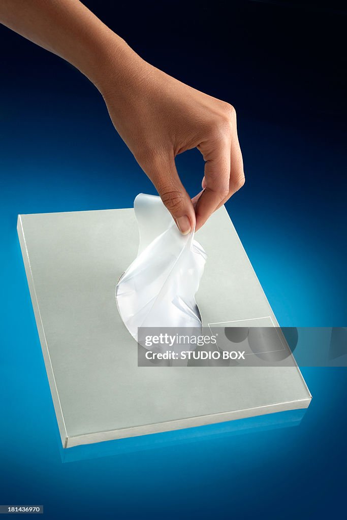Female hands taking a handkerchief from the box
