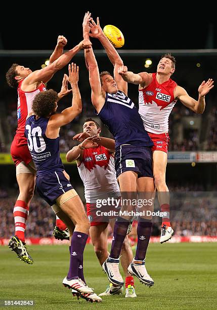 Shane Mumford and Andrejs Everitt of the Swans contest for the ball against Aaron Sandilands of the Dockers during the AFL Second Preliminary Final...