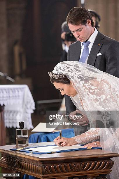 In this handout image provided by the Grand-Ducal Court of Luxembourg, Princess Claire Of Luxembourg and Prince Felix Of Luxembourg are seen signing...