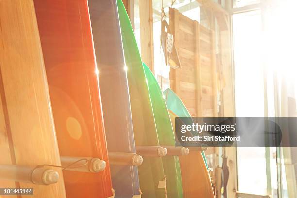 surfboards stacked up in a line in a rack - manhattan beach stock-fotos und bilder