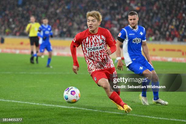 Ritsu Doan of SC Freiburg and Fabian Nürnberger of SV Darmstadt 98 run after the ball during the Bundesliga match between Sport-Club Freiburg and SV...