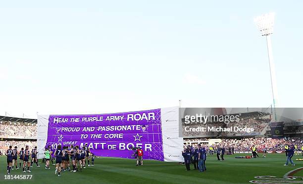 Dockers players run out to their banner during the AFL Second Preliminary Final match between the Fremantle Dockers and the Sydney Swans at Patersons...