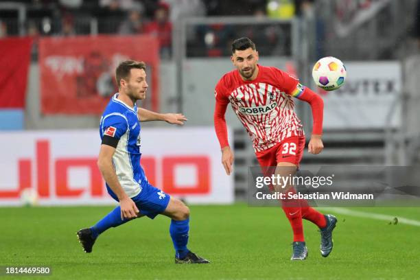 Vincenzo Grifo of SC Freiburg and Matthias Bader of SV Darmstadt 98 compete for the ball during the Bundesliga match between Sport-Club Freiburg and...