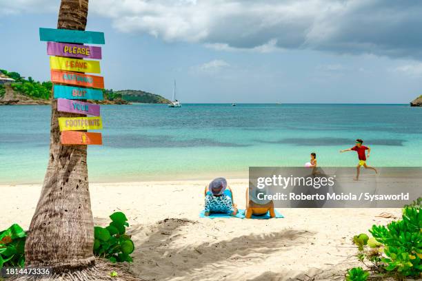 happy little girl and boy playing on a tropical beach - beach sign stock pictures, royalty-free photos & images