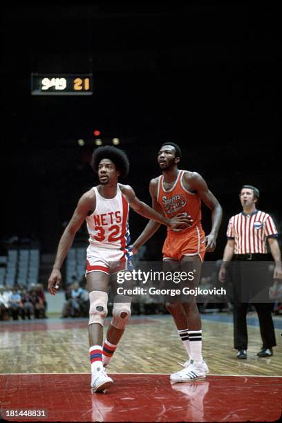 Marvin Barnes of the Spirits of St. Louis grabs the arm of Julius Erving of the New York Nets during an American Basketball Association game at...