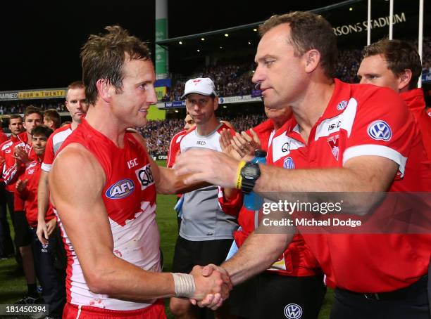 After his last game Jude Bolton of the Swans and coach John Longmire shake hands during the AFL Second Preliminary Final match between the Fremantle...