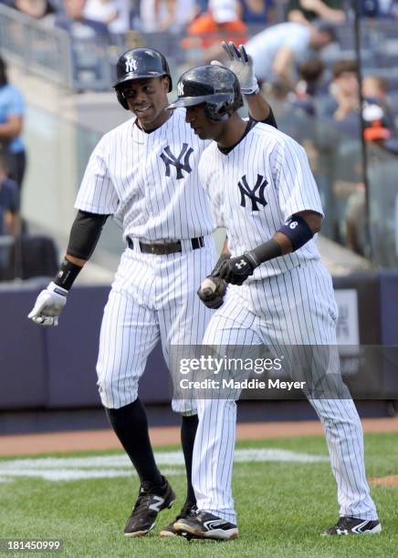 Eduardo Nunez of the New York Yankees celebrates with his teammate Curtis Granderson after hitting a two-run homer during the fourth inning against...