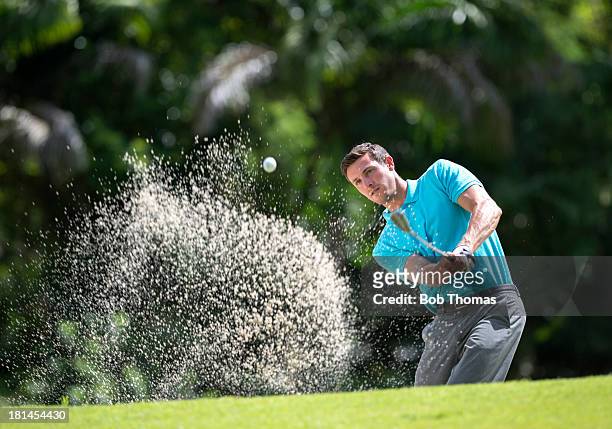 golfer playing out of a bunker - golf shirt stock pictures, royalty-free photos & images