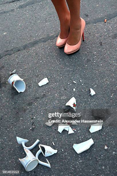 Woman stands next to a broken beer mug during day 1 of the Oktoberfest 2013 beer festival at Theresienwiese on September 21, 2013 in Munich, Germany....