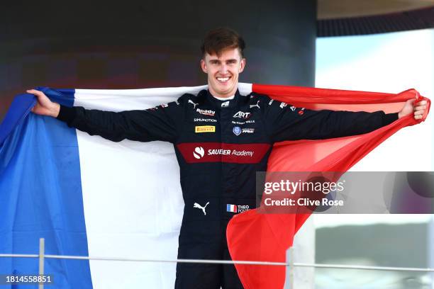 Formula 2 Champion Theo Pourchaire of France and ART Grand Prix celebrates on the podium during the Round 14 Yas Marina Feature race of the Formula 2...