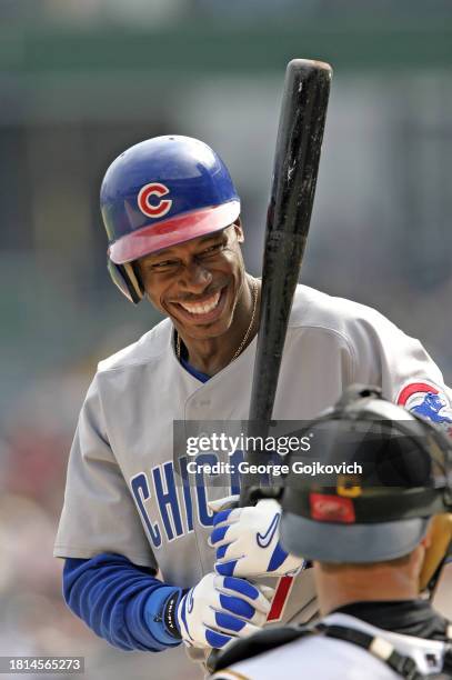 Kenny Lofton of the Chicago Cubs smiles as he talks to catcher Jason Kendall of the Pittsburgh Pirates before batting during a game at PNC Park on...